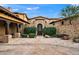 Elegant stone home showcasing a welcoming courtyard with lush greenery and well-maintained landscaping at 16117 E Shooting Star Trl, Fountain Hills, AZ 85268
