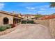 Stately stone home featuring a beautiful brick driveway, mature landscaping, and a classic tiled roof at 16117 E Shooting Star Trl, Fountain Hills, AZ 85268