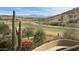 Expansive golf course views from the terrace of this desert home, complete with beautiful cacti and mountain views at 16117 E Shooting Star Trl, Fountain Hills, AZ 85268