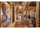 Elegant hallway with arched columns, travertine floors, and decorative lighting, showcases the home's architectural details at 16117 E Shooting Star Trl, Fountain Hills, AZ 85268