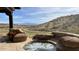 Back patio featuring a stone hot tub overlooking scenic mountain and golf course views at 16117 E Shooting Star Trl, Fountain Hills, AZ 85268