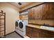 Laundry room with washer, dryer, and ample cabinet space at 16117 E Shooting Star Trl, Fountain Hills, AZ 85268