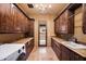 Bright laundry room with ample cabinetry and granite countertops at 16117 E Shooting Star Trl, Fountain Hills, AZ 85268