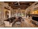 Living room with stone fireplace, high ceilings, and arched windows at 16117 E Shooting Star Trl, Fountain Hills, AZ 85268