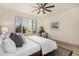 Spacious bedroom with ceiling fan and large window with shutters at 16884 W Pinchot Ave, Goodyear, AZ 85395