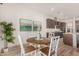 Charming kitchen dining area with wood table and white chairs at 16884 W Pinchot Ave, Goodyear, AZ 85395