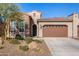 Brick and stucco home with 2-car garage, desert landscaping, and a welcoming front entrance at 16884 W Pinchot Ave, Goodyear, AZ 85395