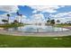 Serene fountain in a community with palm trees and a pond at 16884 W Pinchot Ave, Goodyear, AZ 85395