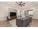 Spacious living area with hardwood floors, large TV, and comfortable seating at 16884 W Pinchot Ave, Goodyear, AZ 85395