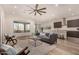 Open concept living space with hardwood floors, comfortable seating, and a modern kitchen at 16884 W Pinchot Ave, Goodyear, AZ 85395
