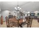 Dining room with round wooden table and six chairs at 18026 N 136Th Way, Sun City West, AZ 85375