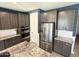 Gray shaker cabinets, granite counters, and stainless steel appliances at 18401 W Long Lake Rd, Goodyear, AZ 85338