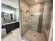 Large walk-in shower with glass enclosure and built-in seat at 18401 W Long Lake Rd, Goodyear, AZ 85338