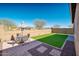 Artificial turf backyard with patio furniture at 18406 W Sunbelt Dr, Surprise, AZ 85374