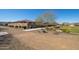 Landscaped backyard with a grassy area and pathway at 18406 W Sunbelt Dr, Surprise, AZ 85374