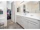 Bright bathroom with double vanity, walk-in shower, and large mirror at 18406 W Sunbelt Dr, Surprise, AZ 85374