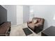 Relaxing bedroom with a comfy armchair and a large TV at 18406 W Sunbelt Dr, Surprise, AZ 85374