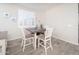 Small dining area with a square table and four chairs at 18406 W Sunbelt Dr, Surprise, AZ 85374