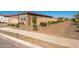 Home's exterior showcases a landscaped yard and walkway at 18406 W Sunbelt Dr, Surprise, AZ 85374