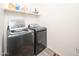 Laundry room with washer, dryer, and overhead shelving at 18406 W Sunbelt Dr, Surprise, AZ 85374