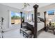 Main bedroom with a large four-poster bed and plenty of natural light at 18844 E Blue Sky Dr, Rio Verde, AZ 85263