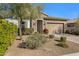 Single story home with stone accents and landscaped yard at 18844 E Blue Sky Dr, Rio Verde, AZ 85263