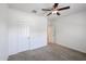 Bright bedroom with ceiling fan and neutral carpeting at 21166 W Monte Vista Rd, Buckeye, AZ 85396