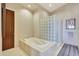 Relaxing bathroom with soaking tub and glass block shower at 24350 N Whispering Ridge Way # 49, Scottsdale, AZ 85255