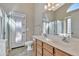 Double vanity bathroom with a large mirror and walk-in shower at 29864 N Desert Willow Blvd, San Tan Valley, AZ 85143