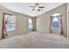 Well-lit bedroom with dual windows and ceiling fan at 29864 N Desert Willow Blvd, San Tan Valley, AZ 85143