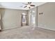 Spacious bedroom with window, ceiling fan and access to bathroom at 29864 N Desert Willow Blvd, San Tan Valley, AZ 85143