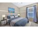 Spacious bedroom with window, ceiling fan, and plush bedding at 29864 N Desert Willow Blvd, San Tan Valley, AZ 85143