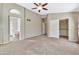 Spacious bedroom with ceiling fan and en-suite bathroom access at 29864 N Desert Willow Blvd, San Tan Valley, AZ 85143