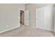 Well-lit bedroom with access to bathroom and carpet floor at 29864 N Desert Willow Blvd, San Tan Valley, AZ 85143