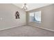 Simple dining room with carpet, chandelier, and wall decor at 29864 N Desert Willow Blvd, San Tan Valley, AZ 85143