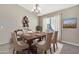 Bright dining room featuring a wood table and six chairs at 29864 N Desert Willow Blvd, San Tan Valley, AZ 85143