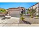 Desert landscape front yard with single story home, two car garage, and neutral color scheme at 29864 N Desert Willow Blvd, San Tan Valley, AZ 85143