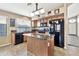 Kitchen boasts granite counters, island, and black appliances at 29864 N Desert Willow Blvd, San Tan Valley, AZ 85143