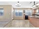 Kitchen with wood cabinets, granite counters, and black appliances at 29864 N Desert Willow Blvd, San Tan Valley, AZ 85143