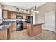 Kitchen with island, wood cabinets, and granite countertops at 29864 N Desert Willow Blvd, San Tan Valley, AZ 85143