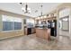 Open kitchen with an island and dark brown cabinets at 29864 N Desert Willow Blvd, San Tan Valley, AZ 85143