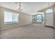 Bright living room with large windows, neutral decor, and a chandelier at 29864 N Desert Willow Blvd, San Tan Valley, AZ 85143