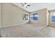 Bright living room with window, carpet, and tile flooring, along with a ceiling fan at 29864 N Desert Willow Blvd, San Tan Valley, AZ 85143