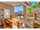 Covered patio with dining area, adjacent to refreshing pool at 29864 N Desert Willow Blvd, San Tan Valley, AZ 85143