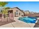 Sparkling blue pool with waterfall and ample patio space at 29864 N Desert Willow Blvd, San Tan Valley, AZ 85143