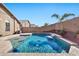 Refreshing blue pool with waterfall feature and desert landscaping at 29864 N Desert Willow Blvd, San Tan Valley, AZ 85143