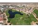 Breathtaking aerial view of the golf course community with a picturesque pond and well-maintained greens at 319 S 227Th Ct, Buckeye, AZ 85326