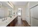 Double vanity bathroom with wood cabinets and a shower at 319 S 227Th Ct, Buckeye, AZ 85326