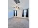 Bedroom with neutral carpet, ceiling fan, and windows with dark curtains at 319 S 227Th Ct, Buckeye, AZ 85326