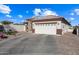 One-story home with a two-car garage and desert landscaping at 319 S 227Th Ct, Buckeye, AZ 85326